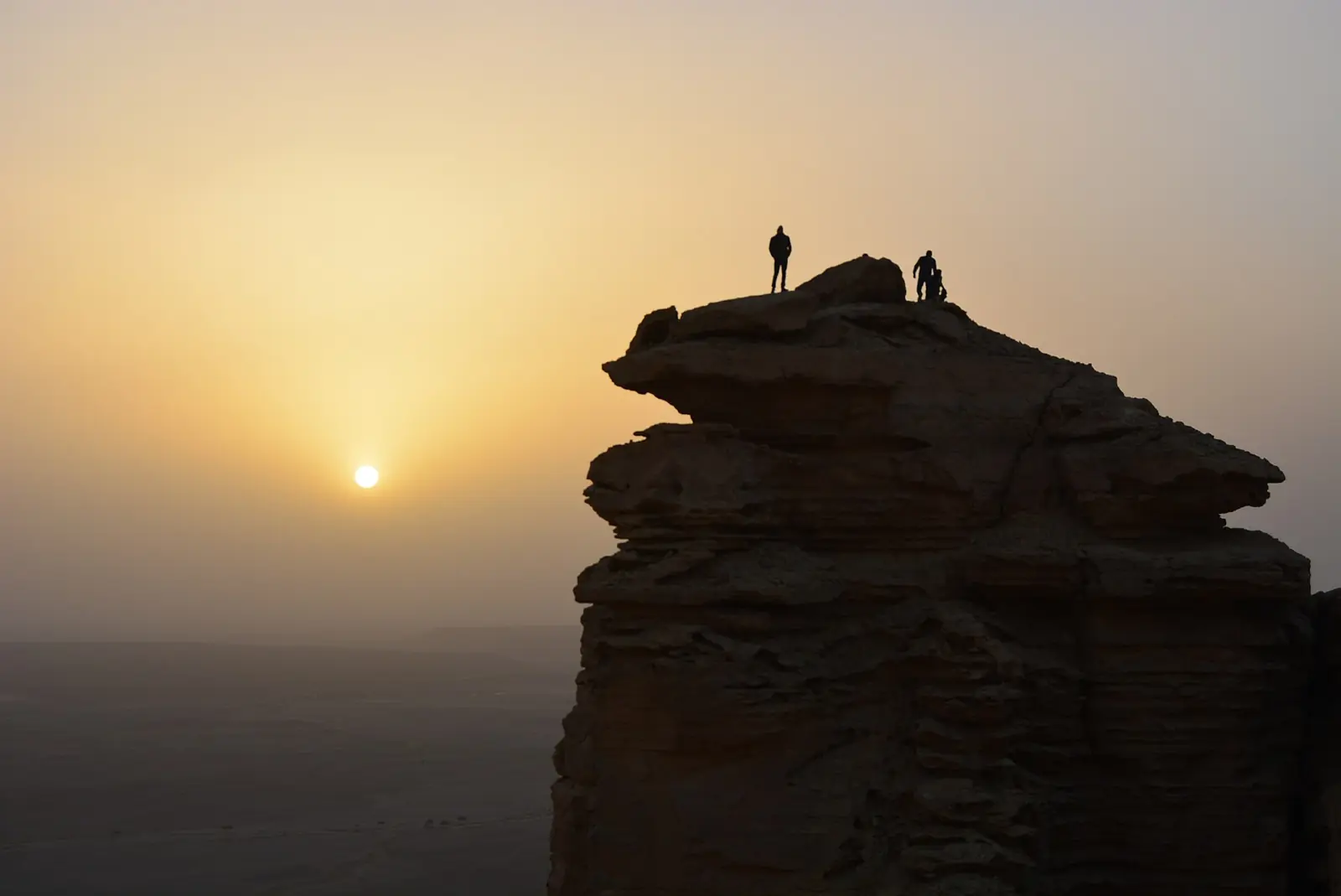 Hikers near the cliff edge at Edge of the World outside Riyadh