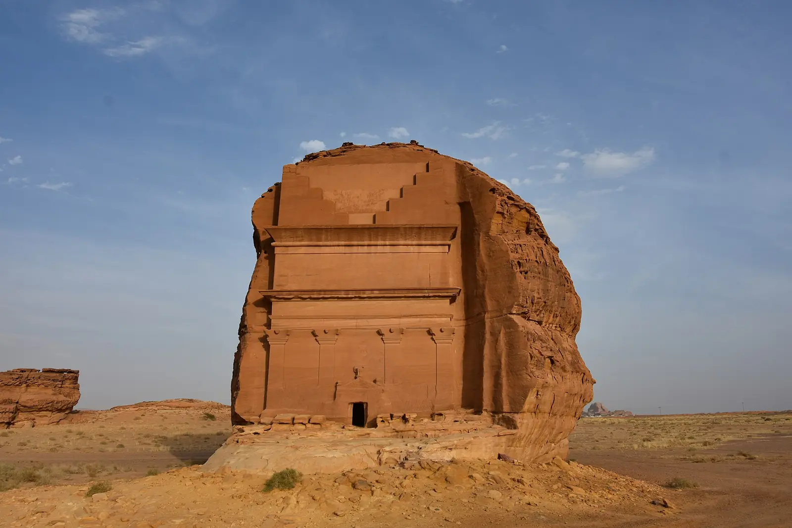 Qasr al-Farid, the lone rock-cut tomb at Hegra, under a clear sky